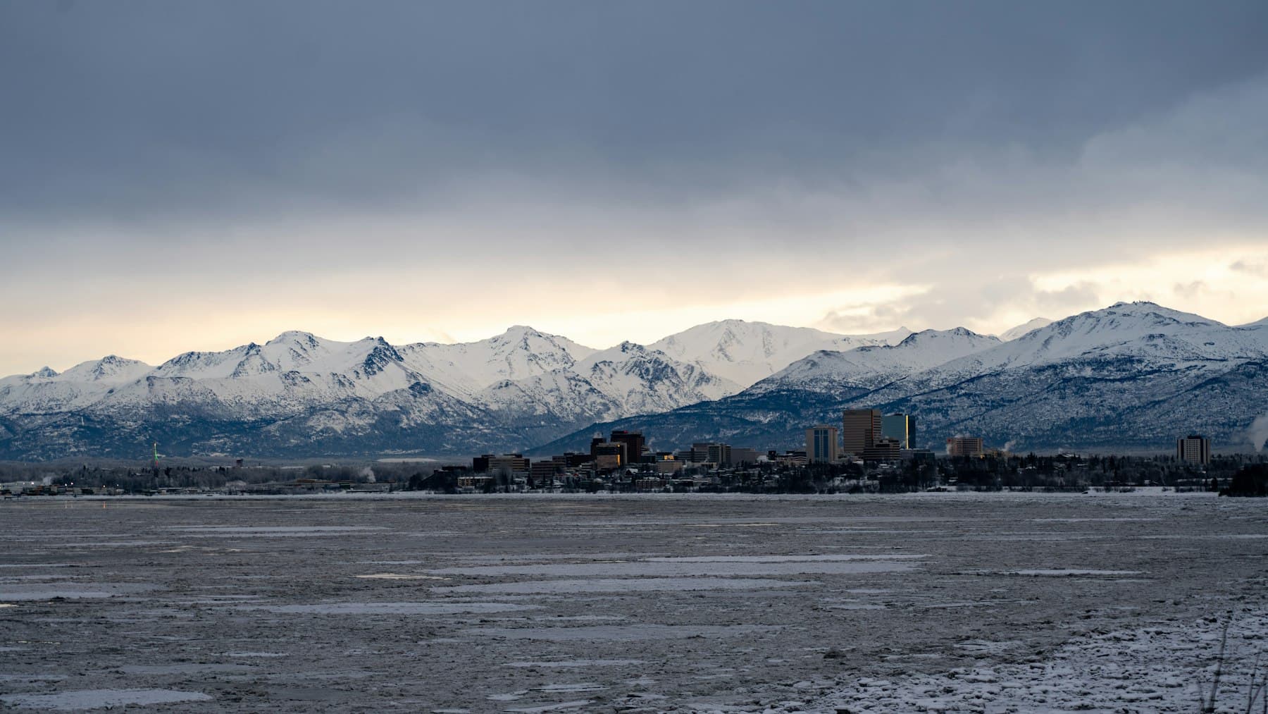 Anchorage, Alaska skyline in winter with the snow-covered Chugach Mountains behind