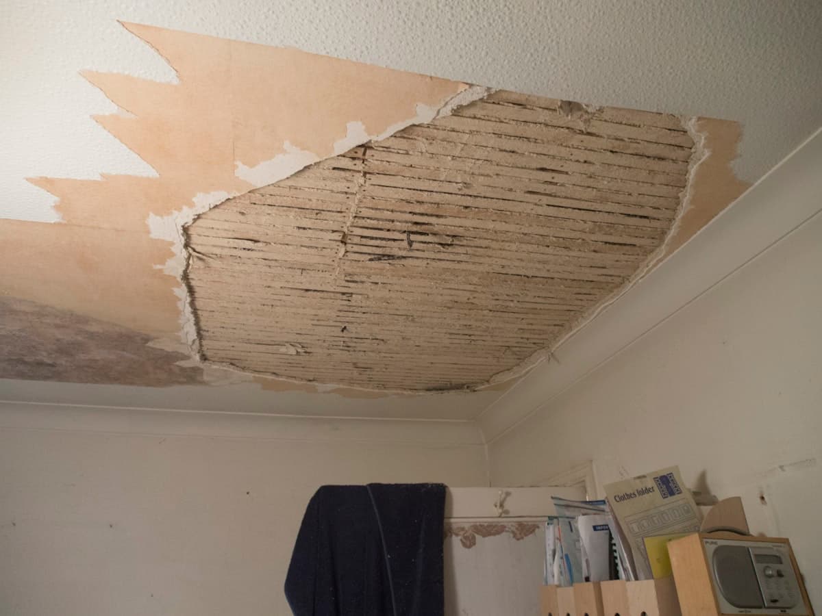 Collapsed ceiling plaster exposing lath after a water loss